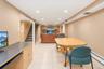 Recessed lighting, light-toned wall finishes, tiled flooring, built-in display shelving, and wood-finish cabinetry