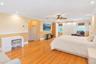 Wood-finish flooring throughout, with crown molding and recessed lighting