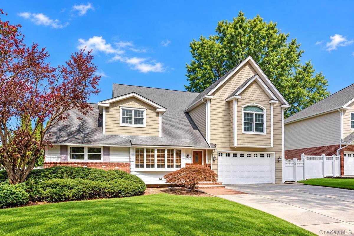 Two-story home with a gabled roof and bay window
