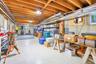 Great storage, exposed wood ceiling beams, concrete walls, painted concrete flooring, and an egress window