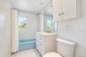 White vanity with ample drawer storage, integrated sink, and coordinating medicine cabinet