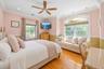 Hardwood flooring, recessed lighting, crown molding, ceiling fan, and large windows with arched detailing