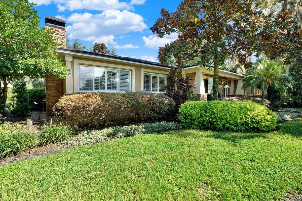 302 BELLE TERRE AVENUE, TEMPLE TERRACE, FL 33617 Front exterior featuring a stone chimney and classic Florida ranch styling.