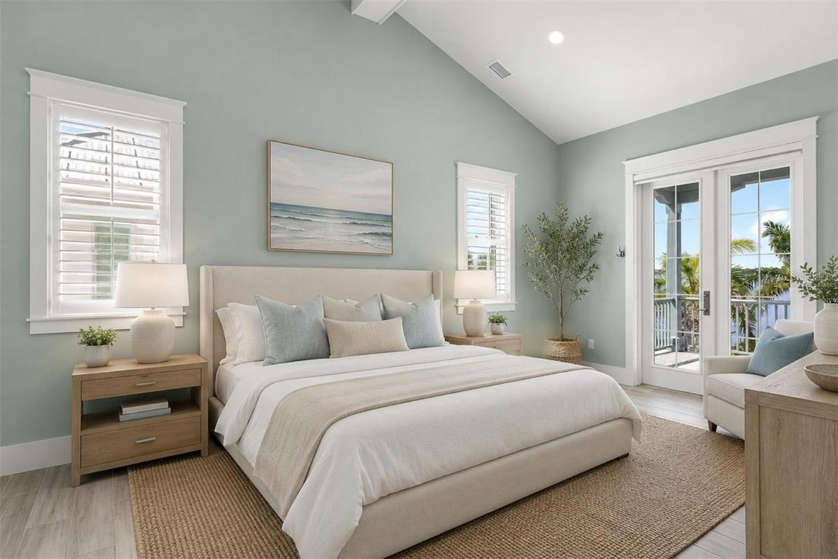 Virtually staged. The second floor primary bedroom with ensuite bathroom, walk-in closet, and a covered balcony
