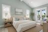 Virtually staged. The second floor primary bedroom with ensuite bathroom, walk-in closet, and a covered balcony