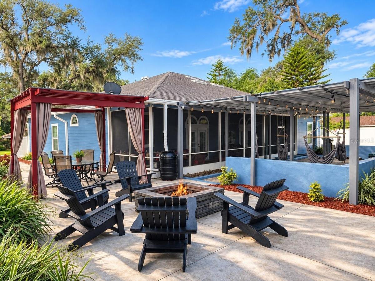 Backyard with fire pit, seating, hammocks