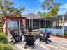 Backyard with fire pit, seating, hammocks