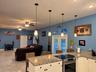 White cabinets and view to living room. Great for entertaining!