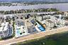 Direct beachfront property featuring multiple residential buildings, outdoor swimming pools, and tennis courts