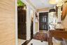 Entryway featuring a paneled door, wood-finish console table, and patterned floor tiles
