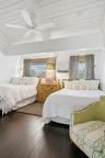 Vaulted wood-plank ceiling, exposed beams, dark wood-finish flooring, recessed lighting, and a ceiling fan