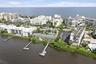 Waterfront community with multiple buildings, an outdoor pool, and private boat docks