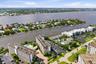Waterfront buildings with multiple docks, surrounded by expansive water features and lush landscaping