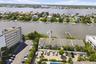 Waterfront property with private dock access, multi-unit building, and shared parking area