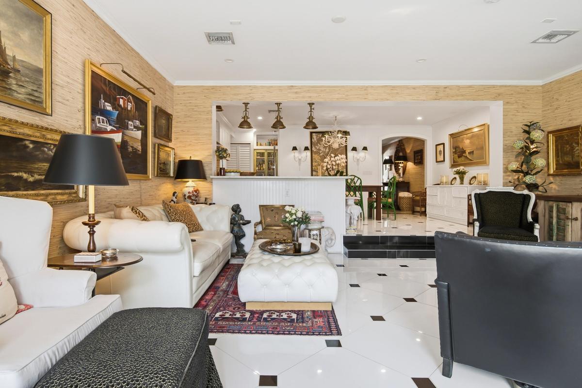 White and black square tiled flooring, textured wall coverings, recessed lighting, and a stepped threshold