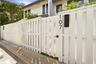 White picket fence with a modern gate and black house numbers