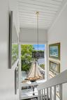 White painted wood plank ceiling with a central pendant fixture