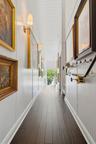 Wood-finish flooring with white baseboards, beadboard wainscoting, and white plank ceiling