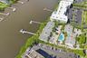 Waterfront property with multiple boat docks, an outdoor swimming pool, and dedicated parking areas