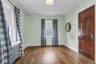 Hardwood flooring, painted walls, white trim, and a paneled wood door