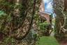 Brick facade with a covered entry and arched columns side porch