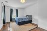 Hardwood flooring, painted walls, ceiling light fixture, and window with radiator below