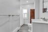 White vanity with a stone countertop and polished chrome fixtures