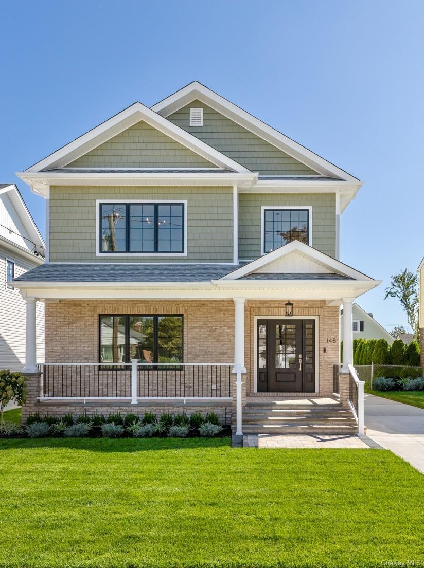 Gable roof lines with shake siding, brick facade, covered front porch, double entry doors. Fully landscaped.