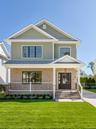 Gable roof lines with shake siding, brick facade, covered front porch, double entry doors. Fully landscaped.