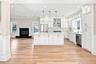 Spacious Kitchen with white shaker cabinetry, stainless steel appliances, and a central island with pendant lighting.