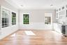 Dining Room - light wood-finish flooring, multiple paneled windows, recessed lighting, built-in cabinetry with glass inserts, and a beverage cooler.