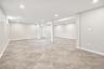 Spacious lower level featuring recessed lighting, light-toned walls, and a ceramic tile flooring.