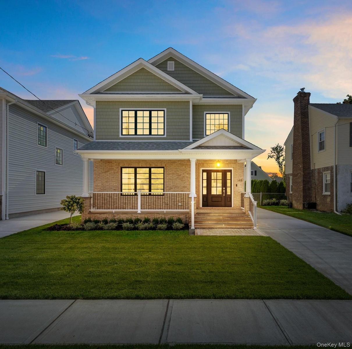 Twilight: Gable roof lines with shake siding, brick facade, covered front porch, double entry doors.