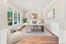 Flexible space: office, study, den, playroom. Wood-finish flooring, white paneled wainscoting, crown molding, recessed lighting, and multiple windows 