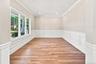 Flexible space: office, study, den, playroom. Wood-finish flooring, white paneled wainscoting, crown molding, recessed lighting, and multiple windows 