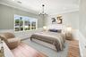 Primary Bedroom with hardwood flooring, crown molding, wainscoting, recessed lighting.VIRTUAL STAGING