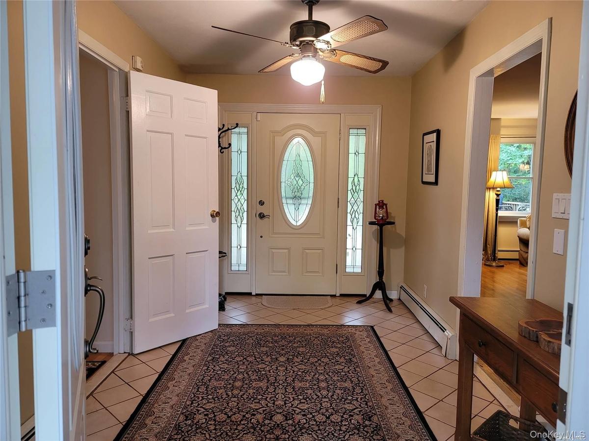 Center hall entry flows to living area and bedrooms with central access to deck and parklike yard
