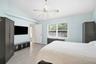 Primary bedroom with walk in closet, en suite bathroom and overlooking beautiful backyard.