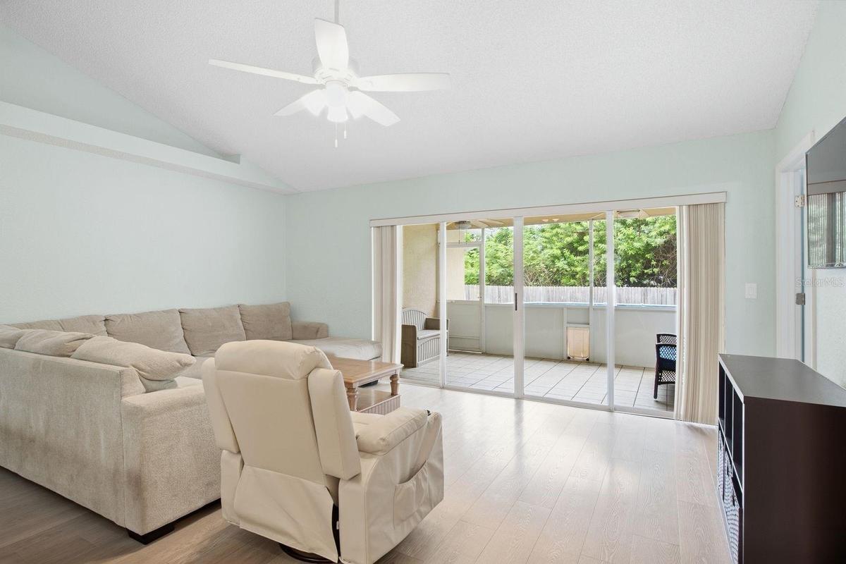 Sunlit living room with a lovely view outdoors.
