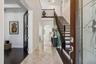 The foyer connects the private office and elegant staircase