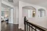 The upstairs landing opens to the loft and bedroom wing.
