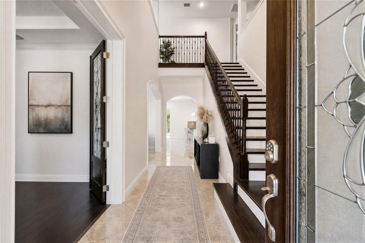 Virtually staged foyer illustrating one way to furnish the space.