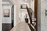 Virtually staged foyer illustrating one way to furnish the space.