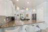 A closer look at the kitchen’s gray quartz peninsula and cabinetry.