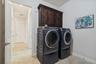 The laundry room offers a convenient transition from the three car garage into the home.
