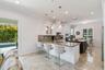 An open kitchen and living area flows through sliding doors to the backyard