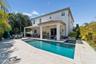 A heated pool and spa framed by the home’s Mediterranean architecture