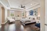 A light-filled primary suite with a tray ceiling and no carpet