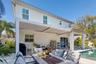 An adjustable louvered pergola lets you open the roof to the sun or close it for shade.