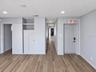 On the left are the entrance door to Office 1, a hallway leading to other offices, and the door to a half-bath.
